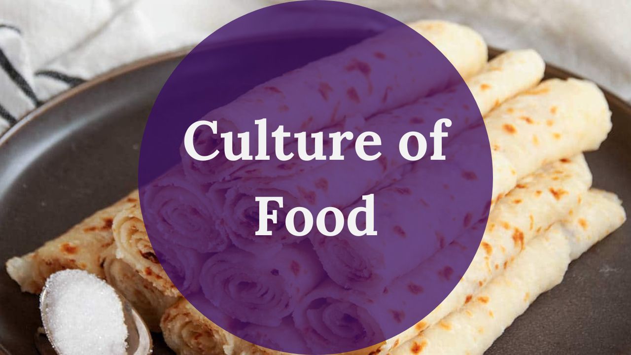 A purple circle reading Culture of Food in white text over a photo of a plate of a rolled lefse stack and a spoonful of sugar on a dark plate.